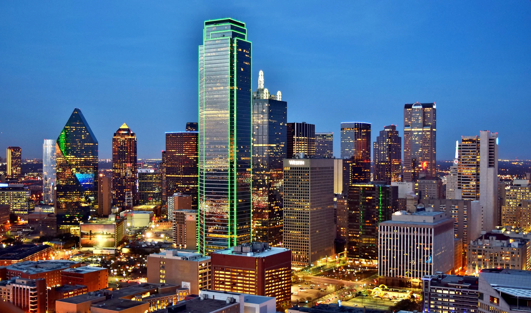 Illuminated buildings in the Dallas skyline at dusk